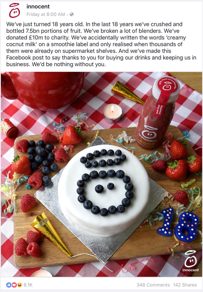 A promotional image showing a cake surrounded by bottles of smoothies, raspberries, and a lit candle, celebrating Innocent's charitable donations and successes, designed with Biteable video maker.