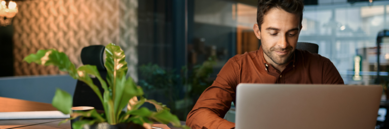 Man working on Biteable video maker in office environment after hours.