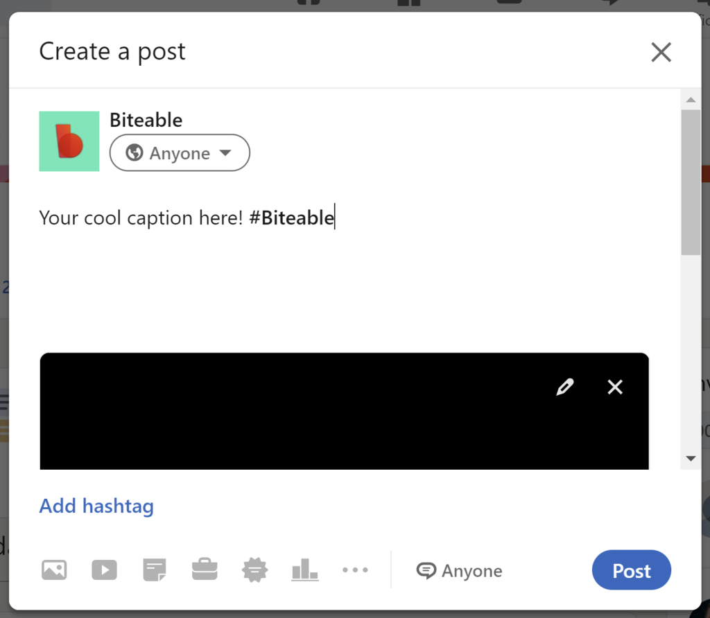 A screenshot of a social media post creation interface with the text "your cool caption here! #biteable" in the post box and an attached blacked-out image.