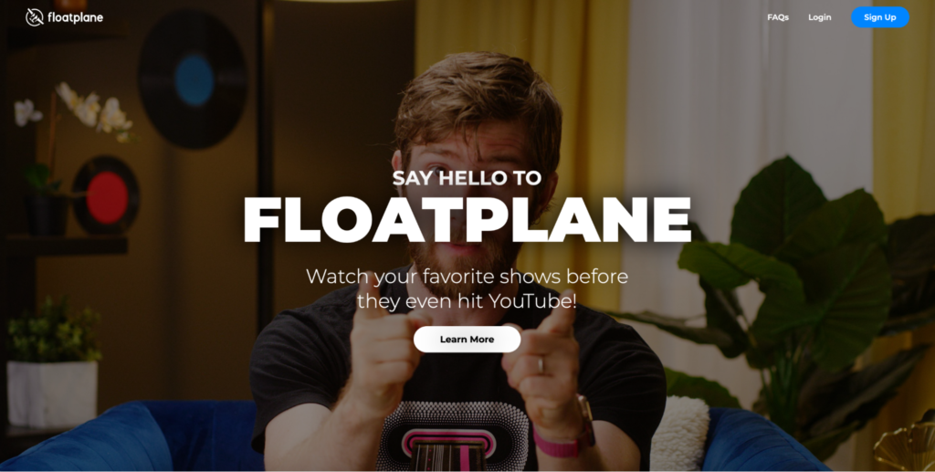 Man holding hands in a framing gesture with text overlay promoting the website 'floatplane' for watching shows before they are available on youtube.