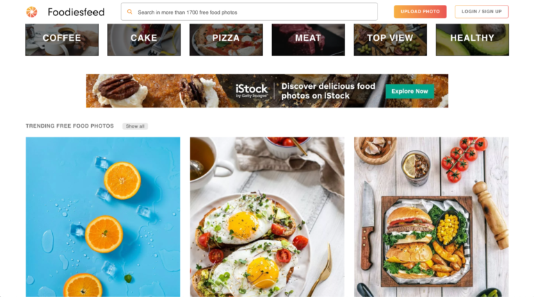 A screenshot of the homepage of the "foodiesfeed" website, one of the best sites for free images, featuring a variety of high-quality images of food.
