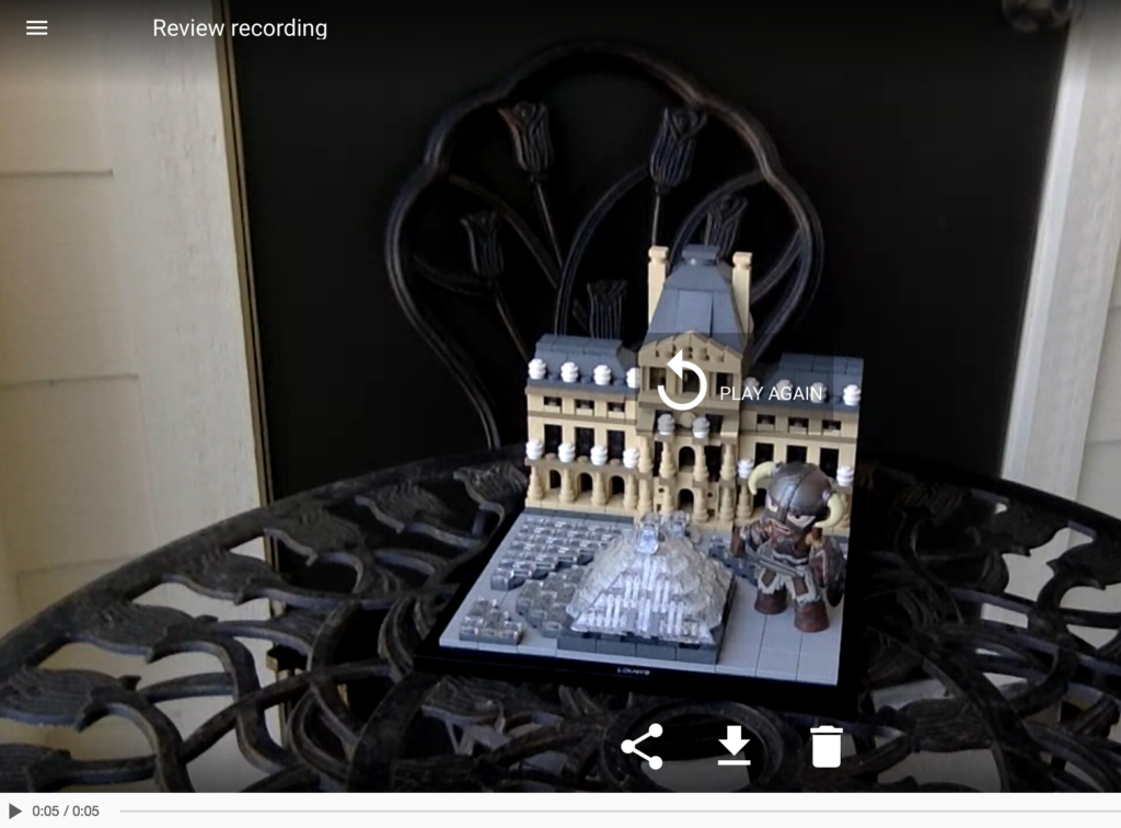 A digital tablet displaying a 3D video tour of a model building created with Biteable video maker and a knight figure on a decorative table.