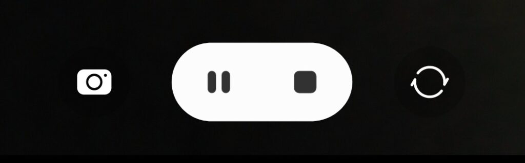 Smartphone screen displaying Biteable video maker camera button, pause button, and replay button.
