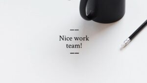 Black computer mouse and pencil on a white surface with the text "nice work team!", created using Biteable video maker.