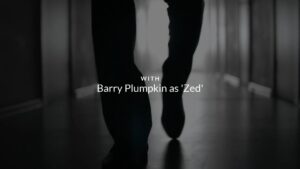 A monochrome Biteable video maker image of a person walking barefoot with the caption "with Barry Plumpkin as 'Zed'".