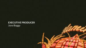 Illuminated carnival ride against a dark background with the text "executive producer June Buggy" created with Biteable video maker, displayed in the foreground.