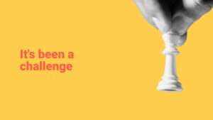 A hand holding a white chess king piece against a yellow background with text saying "Our Year in Review.