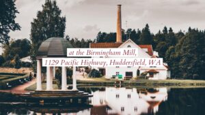 Historic mill building and gazebo by a tranquil body of water, surrounded by lush greenery captures the essence of a perfect scene for a Biteable video maker project.