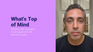 Professional discussing organizational and team goal-setting strategies using Biteable video maker.