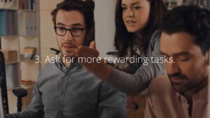 Three colleagues in an office setting, with one gesturing as if explaining something about the Biteable video maker.