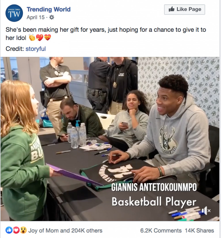 A young girl presents a handmade gift to basketball player Giannis Antetokounmpo at a signing event, captured beautifully in a Biteable video, with expressions of joy and admiration.