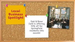 A bulletin board displays a flyer announcing a 10% discount at Oak & Bean Café for Springfield residents and a photo of people sitting inside a bright, modern café.