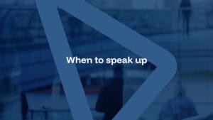 Blue-toned image with the text "When to speak up" centered inside a transparent triangular overlay; blurred people and glass structures in the background.