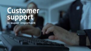 A person types on a keyboard in an office setting, with the text "Customer support is super important" displayed on the image.