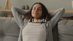 A woman sits on a couch with eyes closed and hands behind her head, appearing relaxed. Text on the image reads, "But Daniela...