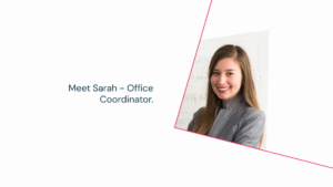 A woman with long brown hair and a gray blazer smiles in front of a whiteboard. Text on the left reads: "Meet Sarah – Office Coordinator.