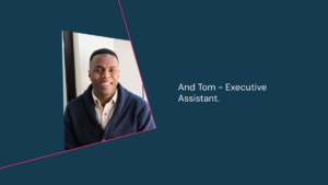 A man in a navy sweater and white shirt smiles at the camera, next to text that reads: "And Tom – Executive Assistant.