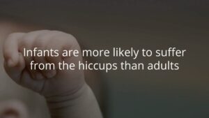 A close-up of an infant's hand with text overlay stating, "Infants are more likely to suffer from the hiccups than adults.