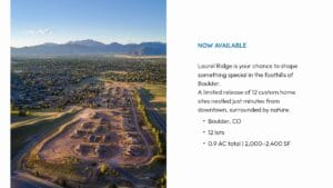 Aerial view of a housing development site with roads and lots marked, set against a backdrop of mountains and a residential area in Boulder, Colorado.