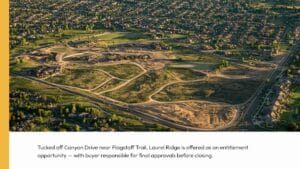 Aerial view of a large, partially developed residential area surrounded by houses and roads, with open land and construction visible in the center.