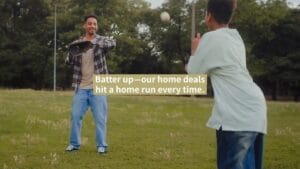Two people play catch with a baseball in a grassy field. Text overlay reads: "Batter up—our home deals hit a home run every time.