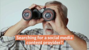 Older man with gray hair and beard looks through binoculars; overlaid text reads, "Searching for a social media content provider?.