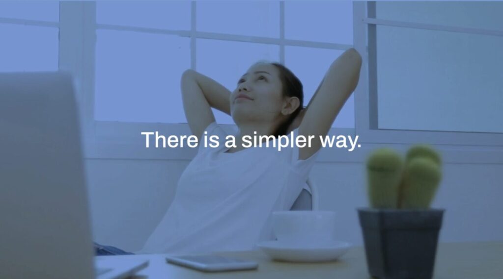 A person leans back in a chair with hands behind their head, looking upward. Text on the image reads: "There is a simpler way.